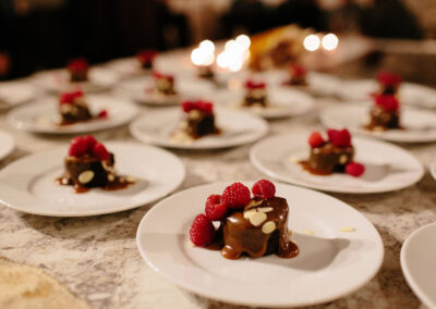 dessert topped with raspberries on table